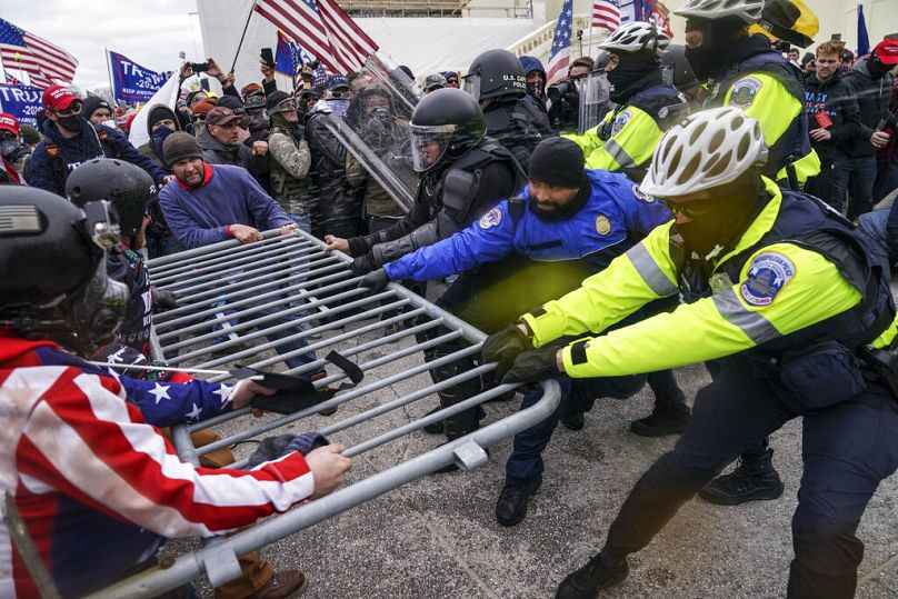 Rioters try to break through a police barrier at the US Capitol in Washington, DC, on 6 January 2021.